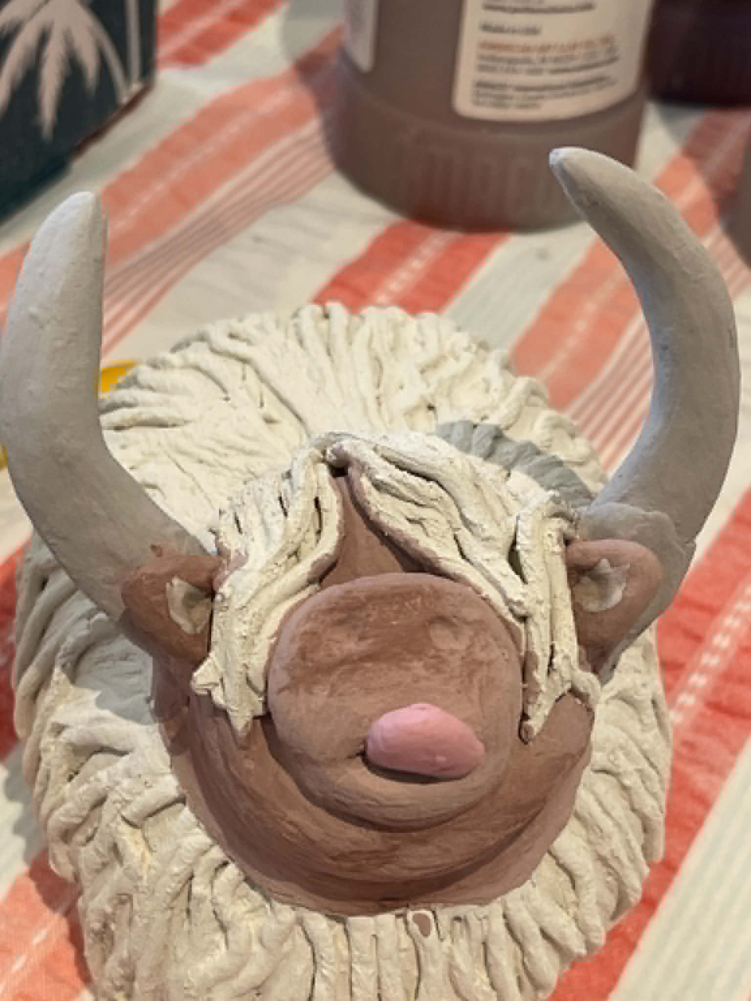 Handmade ceramic Highland cow from an Unruly Clay workshop