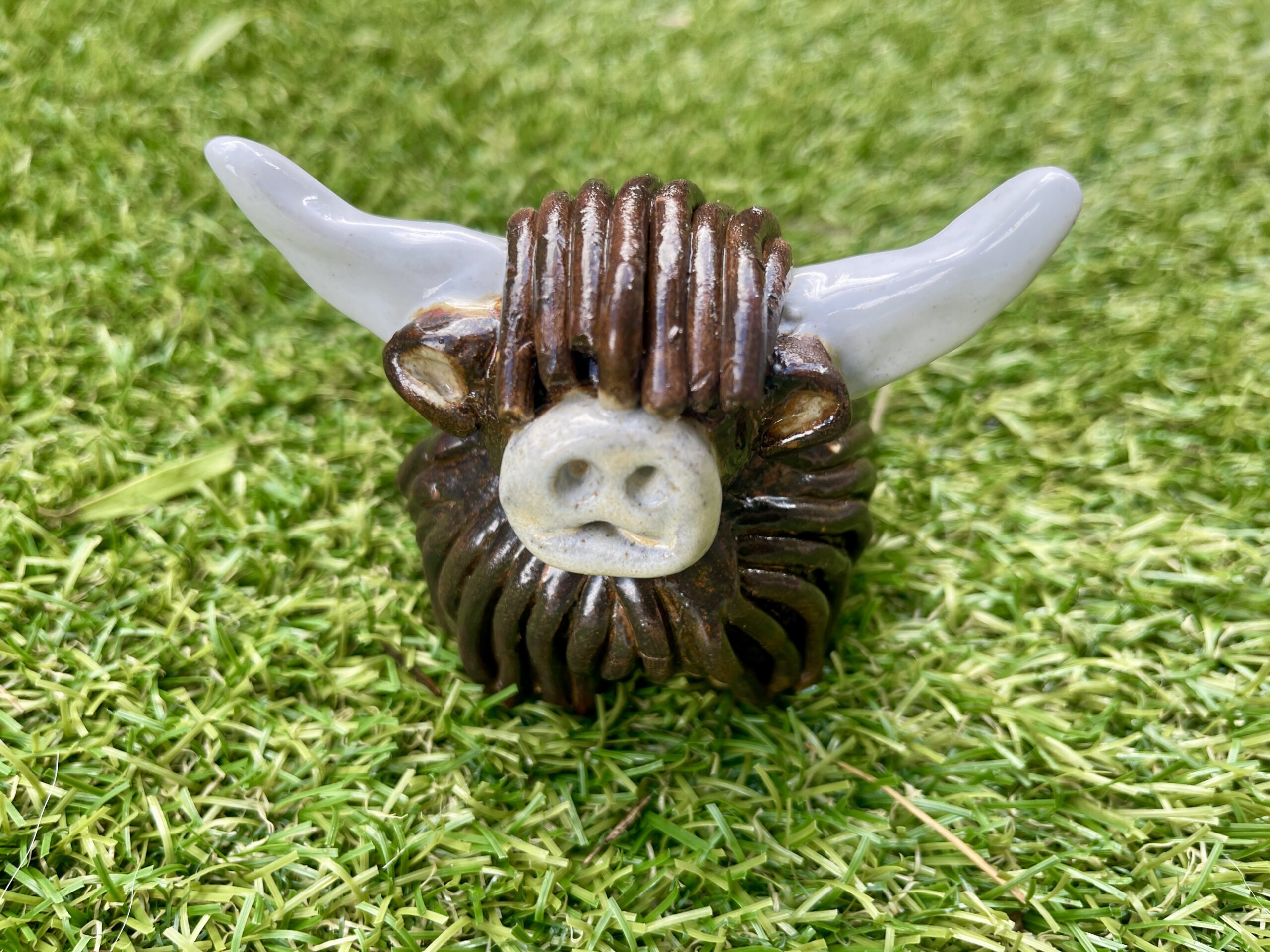 Participants hand-building Highland cows at an Unruly Clay workshop