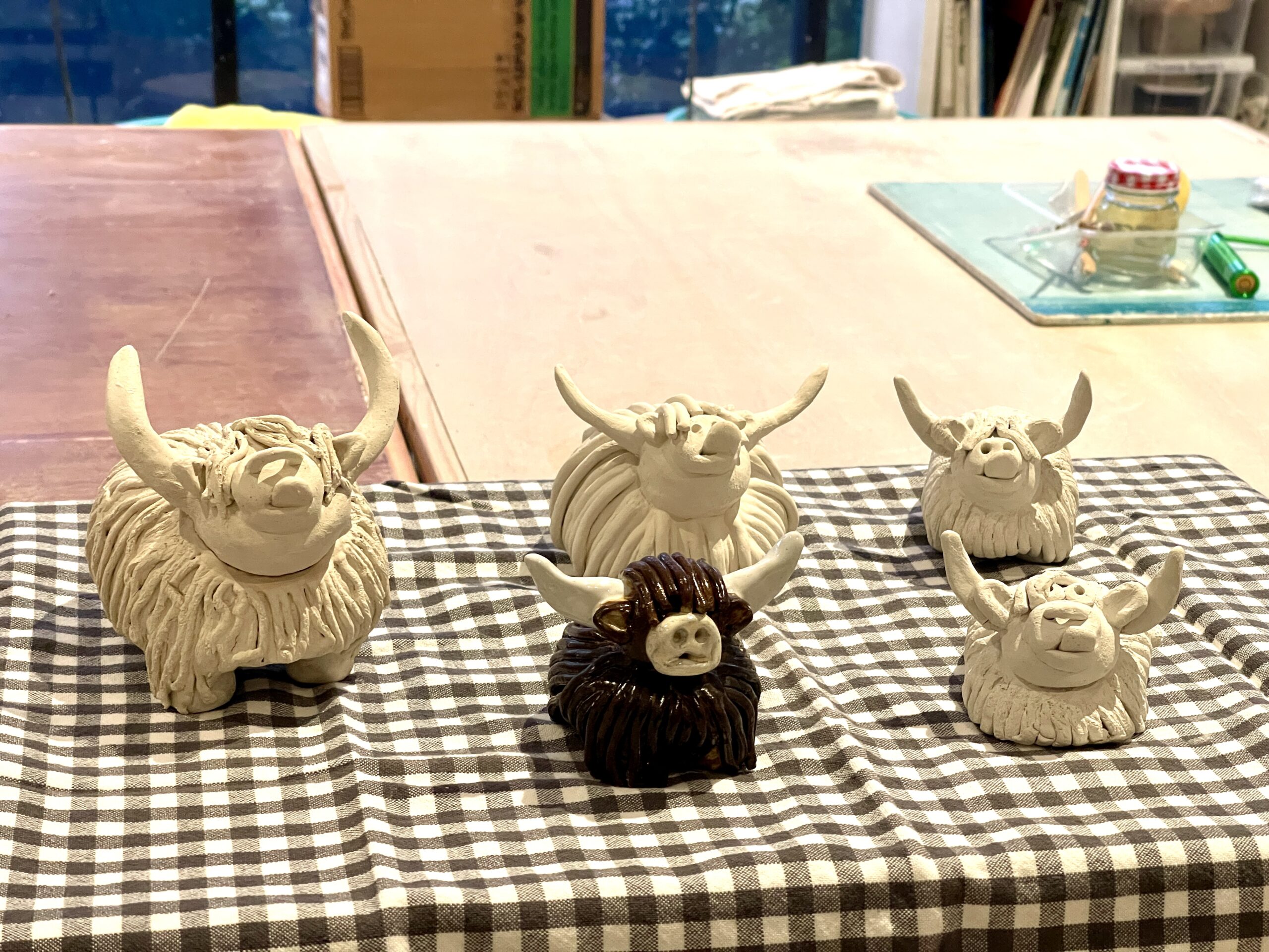 Ceramic Highland cows with funny, expressive faces